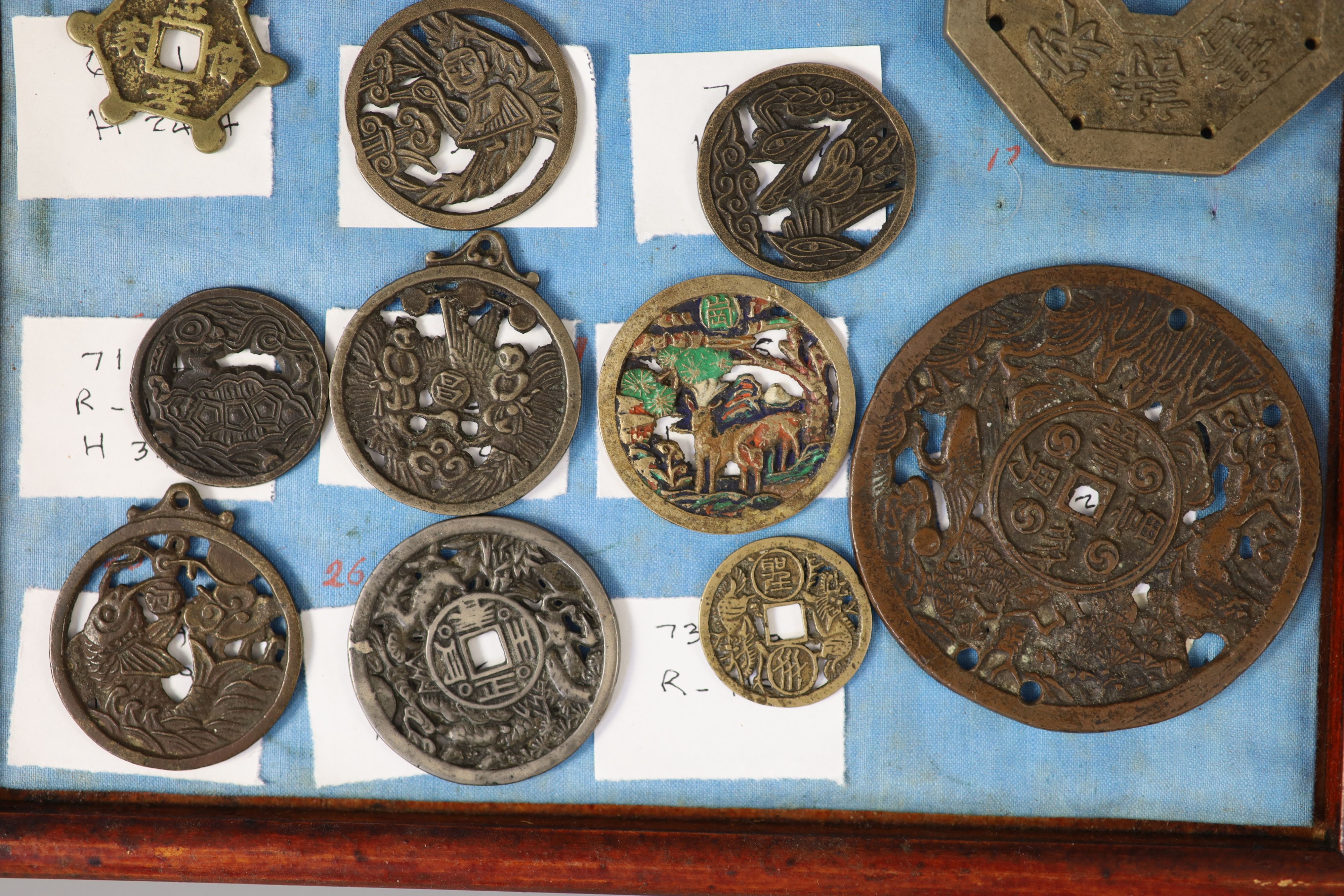 A group of 99 Korean bronze and metal amulets or charms, 19th/20th century